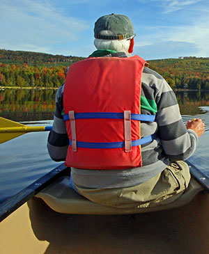 Canoer paddling in the fall